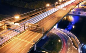 Road bridge across the river at night, view from above